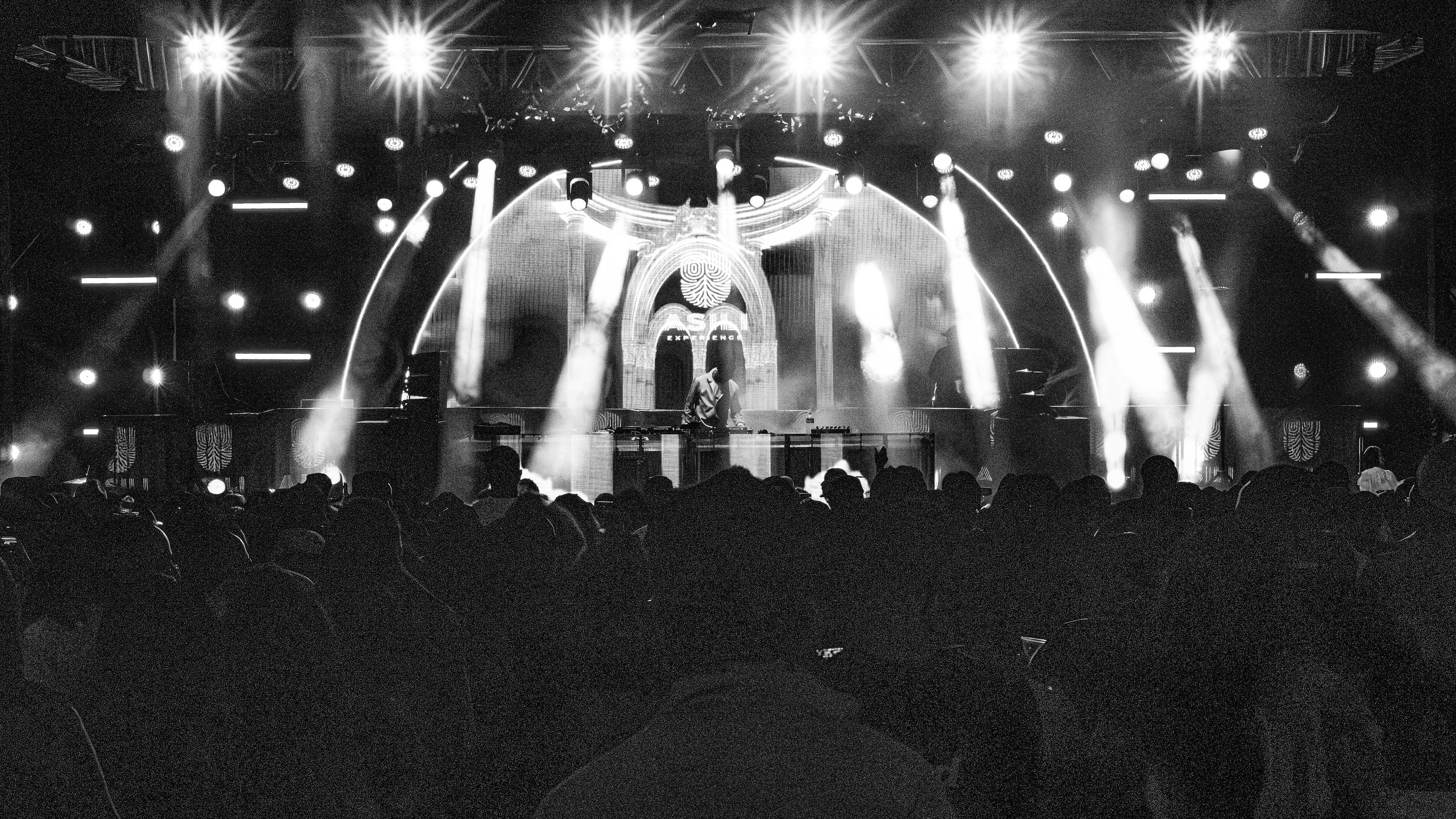 Wide black-and-white view of the ASILI stage and crowd