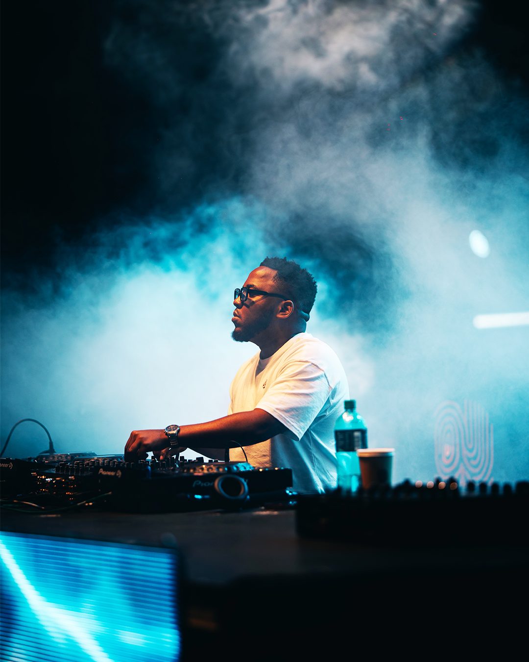 ASILI Experience DJ performing through smoke and lights